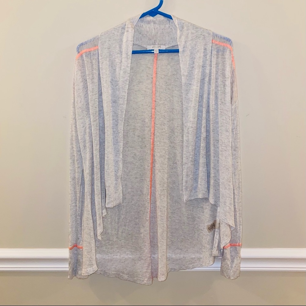 Delia’s beige cardigan